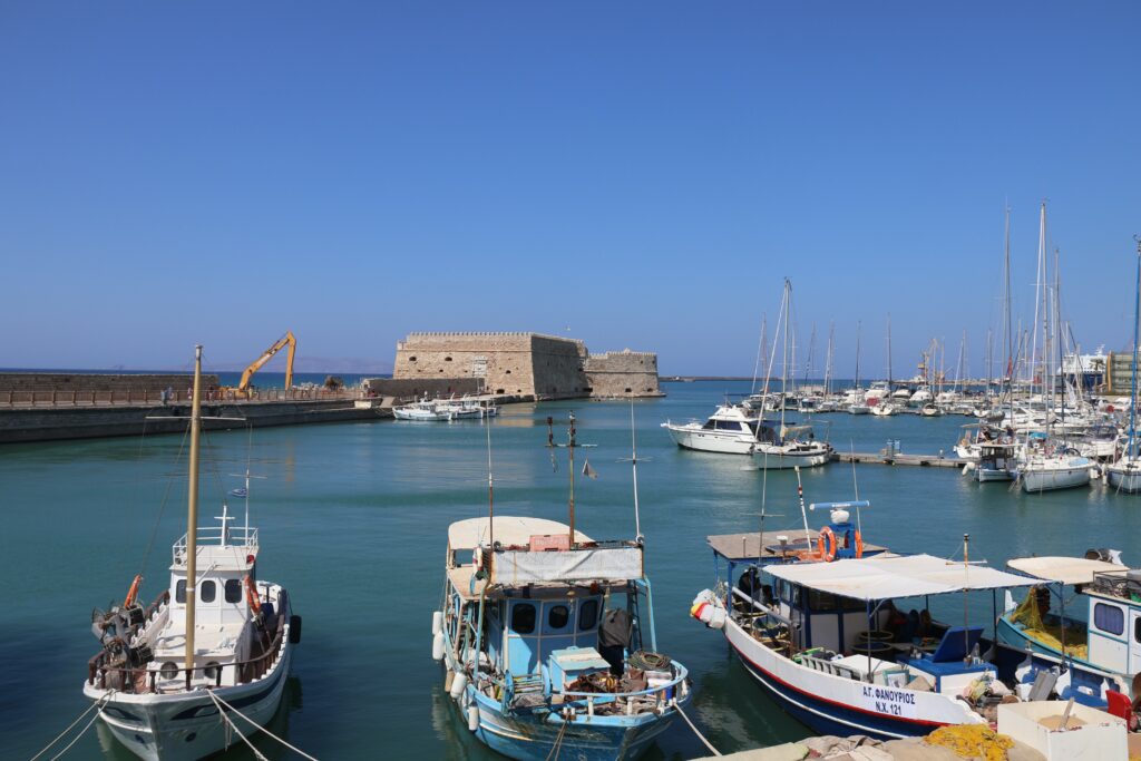 A castel and boats on the sea port.