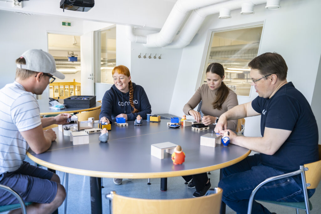 Students and teachers around a table building blocks.